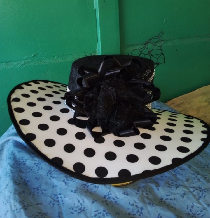 Wide brimmed polka dot hat.