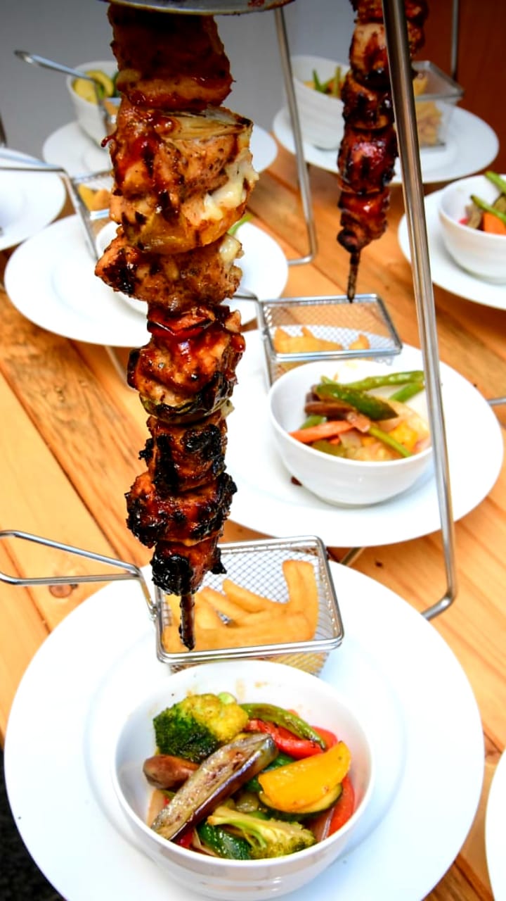 Espetada Stands with Spike and Cup in Stainless Steel. Manufactured from Stainless steel as per food regulations. two sizes: MEDIUM: HOLDS 21CM OF MEAT. LARGE: HOLD 28CM OF MEAT.