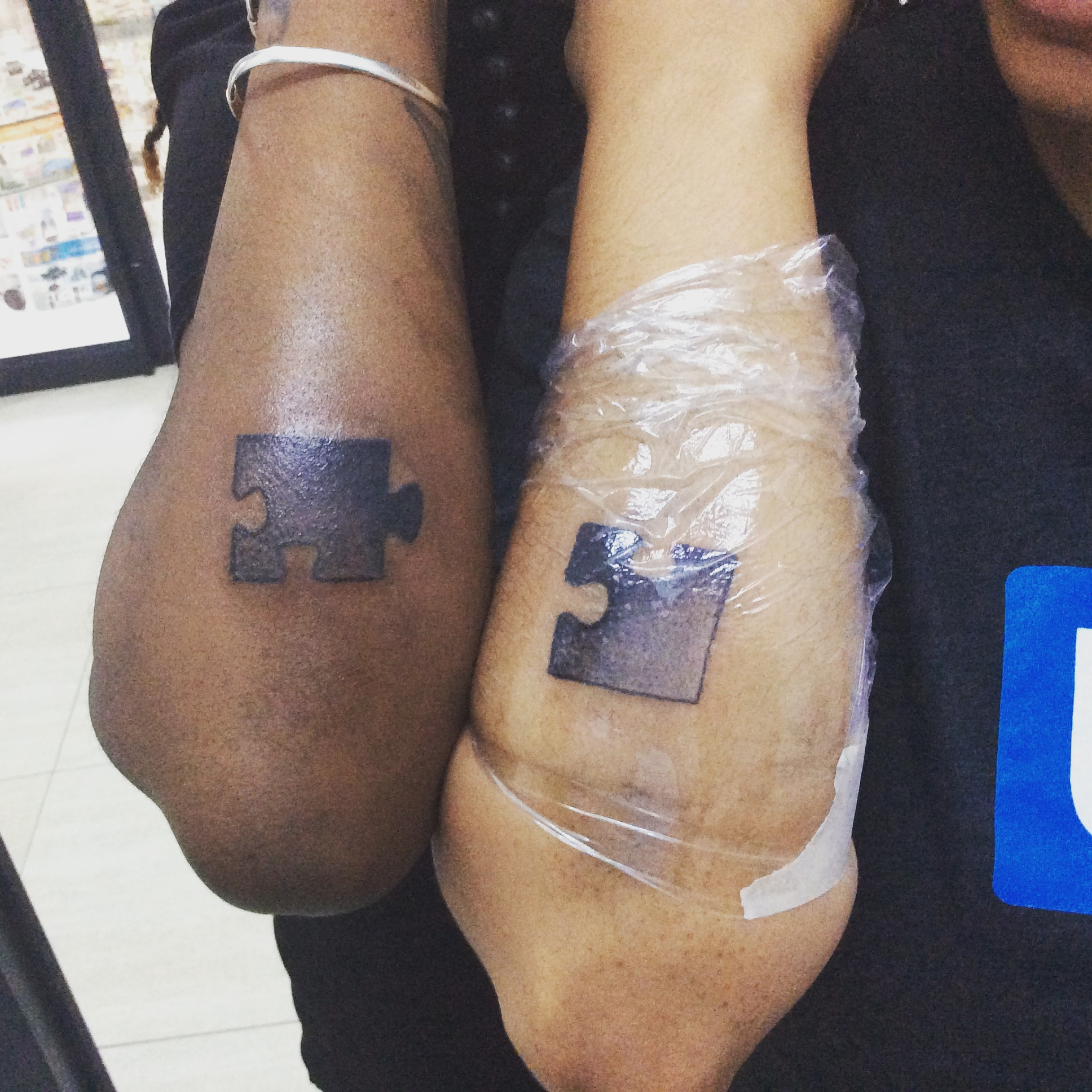 A couple's tattoo of fitting puzzle pieces 