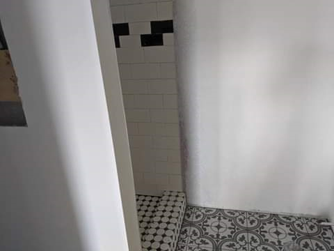 layed out bulded neatly tiled floor walls and shower and painted..